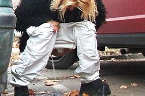 Girl Peeing Among Cars
