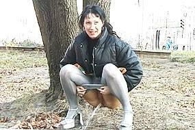Brunette Peeing Behind a Tree
