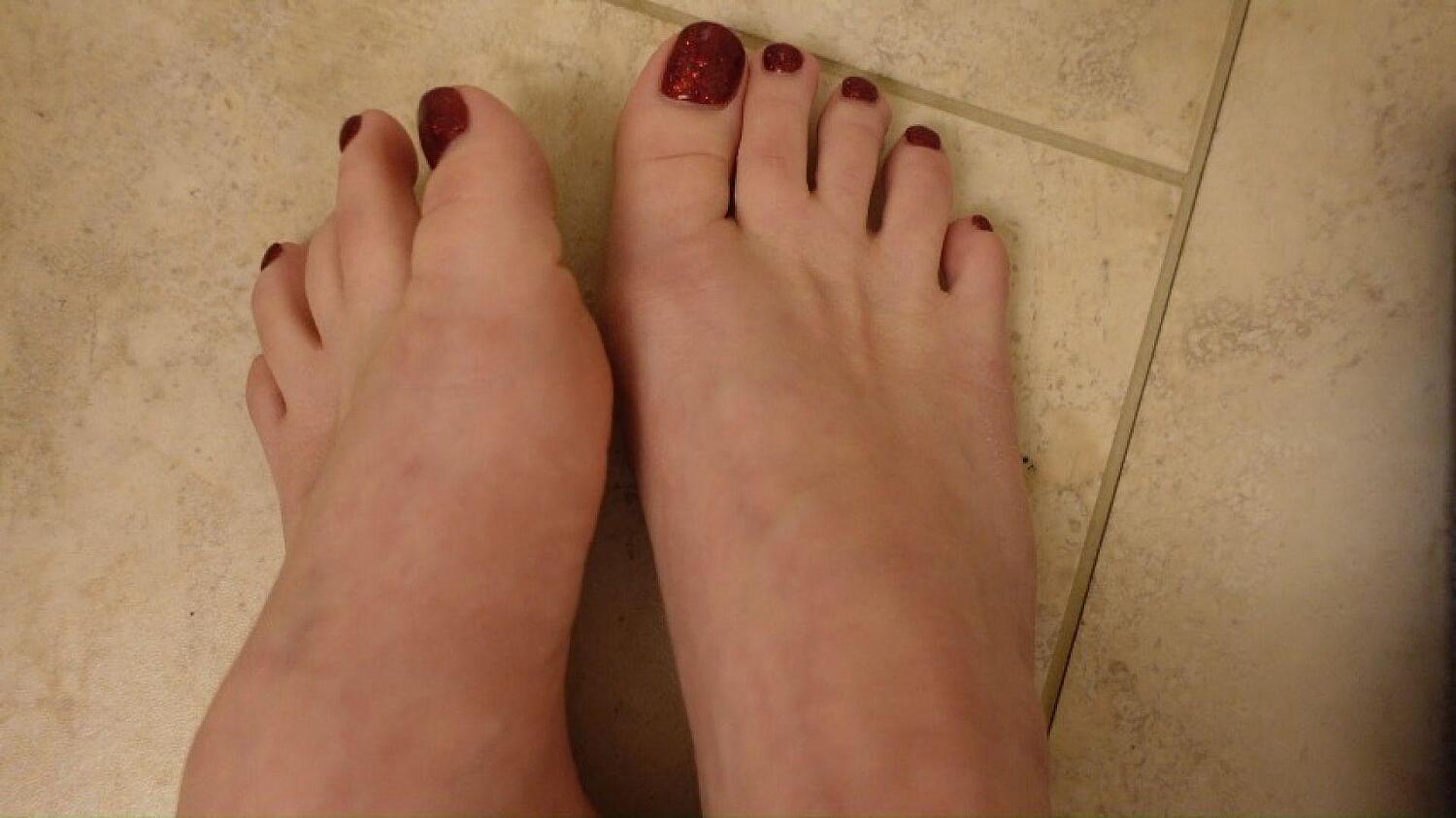Quick New Pedicure Show Off Glittery Red Toenails