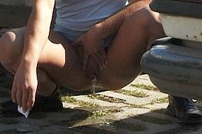 Woman Peeing Next to Car