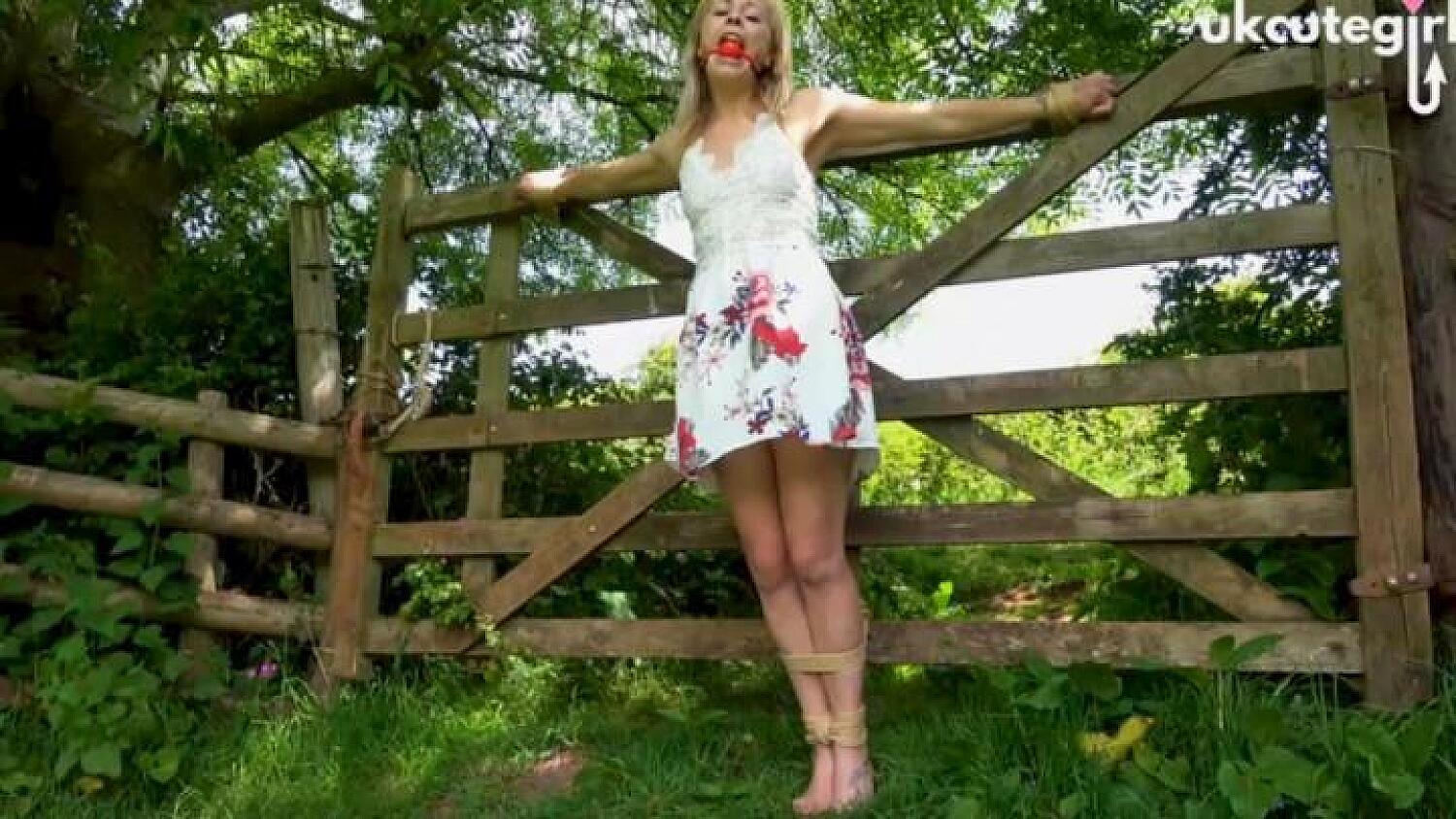 Damsel Tied To Gate Crucifix Bondage & Ballgagged