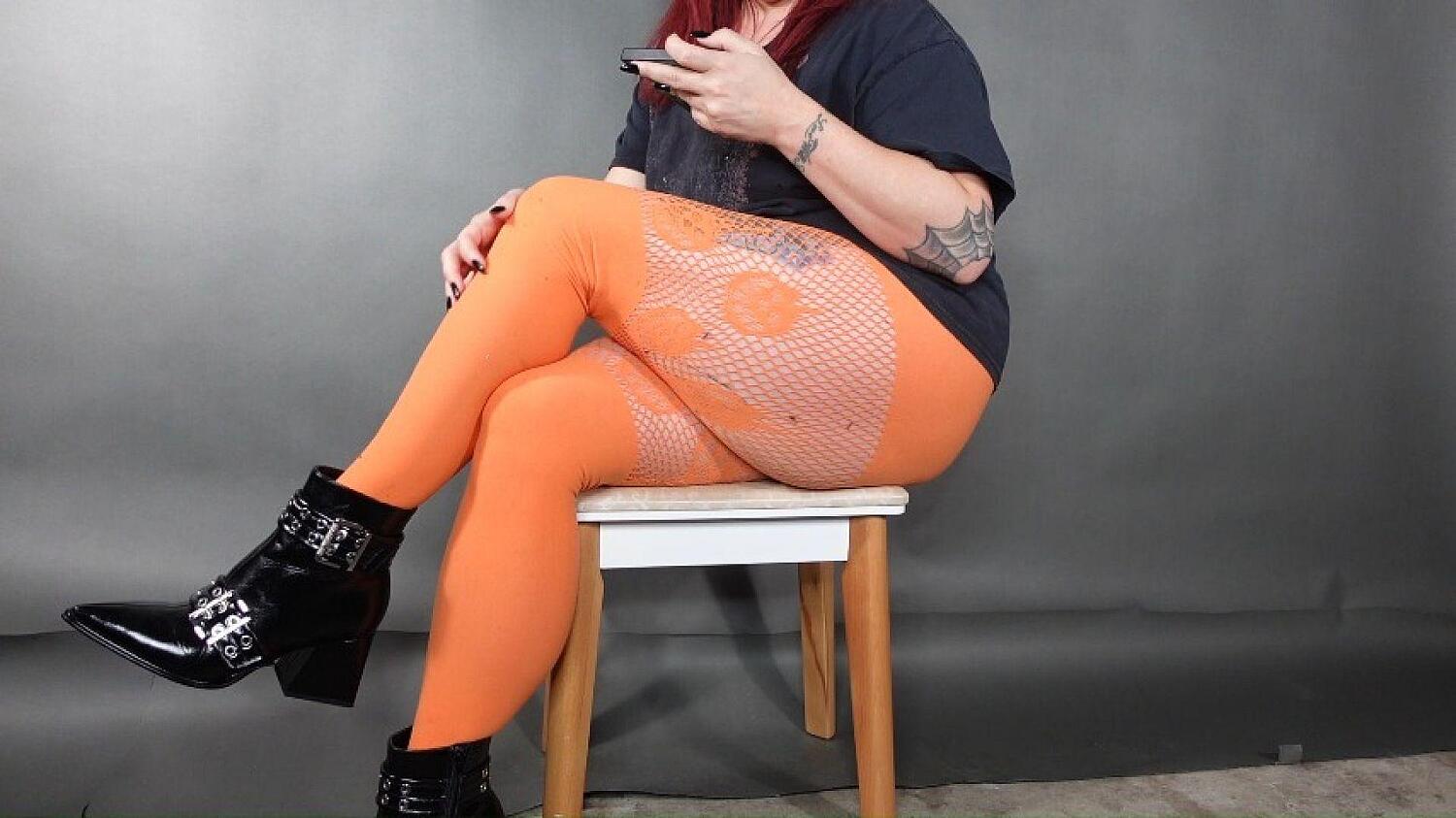 Leg Cross Ignore In Orange Pantyhose And Black Boots