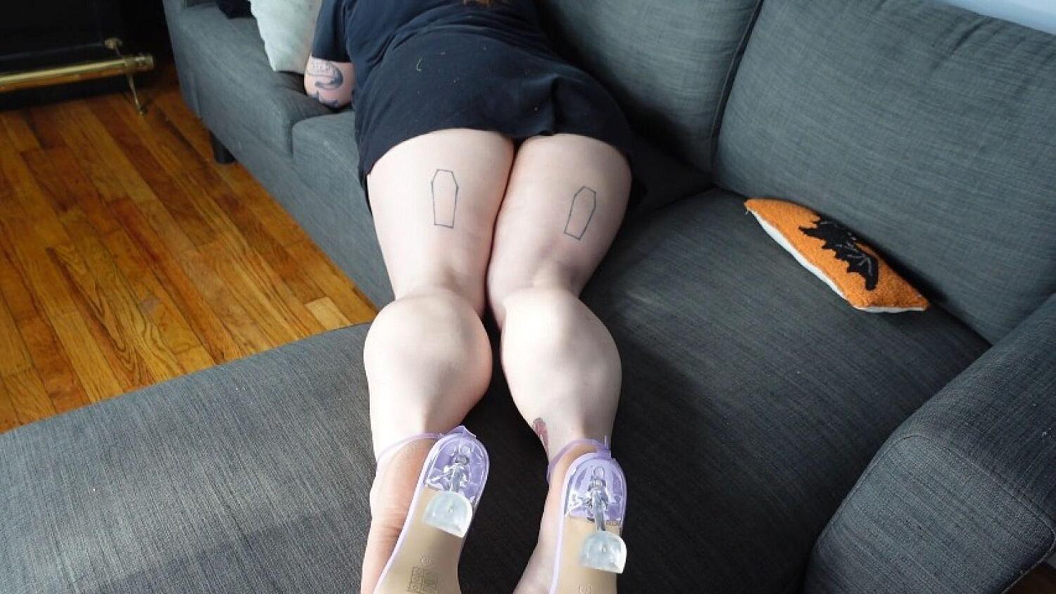 Muscular Calves On Couch In Purple Heels