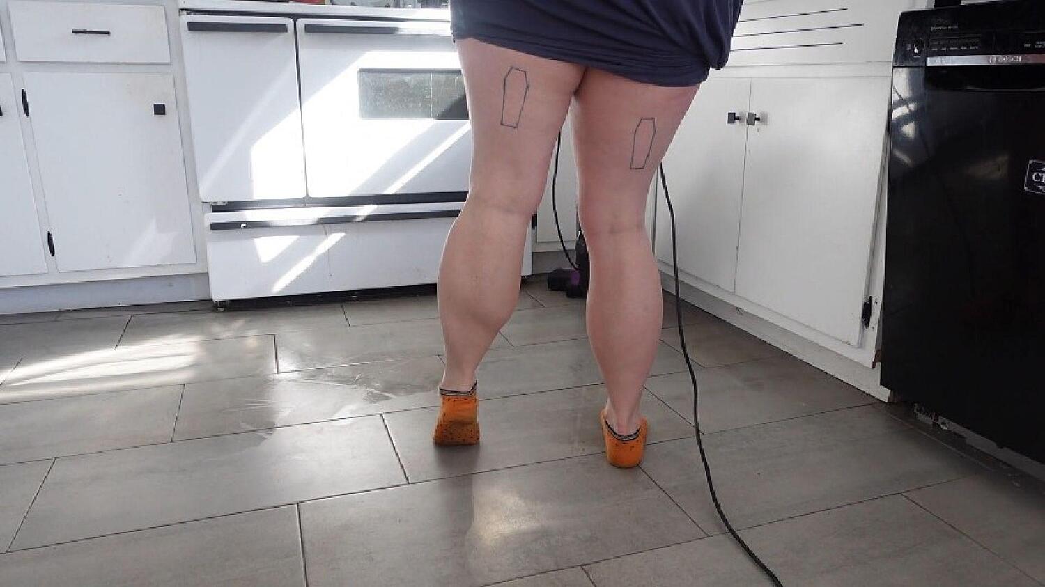 Calves In Orange Ankle Socks While Vacuuming