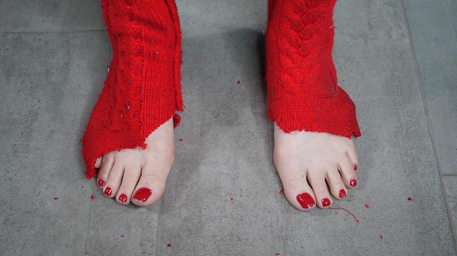 Foot And Leg Growth Out Of Red Thigh High Socks