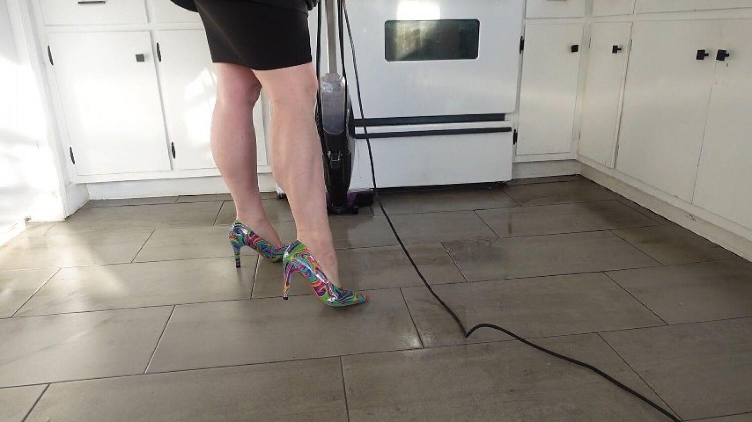 Muscular Calves While Vacuuming In Tie Dye Stilettos