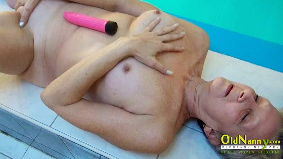 Granny Masturbates with Dildo on the Pool